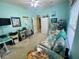 Bright bedroom with a daybed, desk, TV and adjacent closet at 5005 Pebble Beach Blvd, Winter Haven, FL 33884
