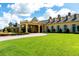 Beautiful clubhouse with manicured lawns and an inviting entrance at 5005 Pebble Beach Blvd, Winter Haven, FL 33884