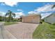 Spacious brick-paved driveway leading to an attached two-car garage of this well-maintained single-story home at 5005 Pebble Beach Blvd, Winter Haven, FL 33884