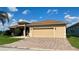 Charming home with well-maintained landscaping, a spacious two-car garage, and a decorative fountain at 5005 Pebble Beach Blvd, Winter Haven, FL 33884