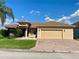 Beautiful home featuring a two-car garage, a fountain, meticulous landscaping, and excellent curb appeal at 5005 Pebble Beach Blvd, Winter Haven, FL 33884