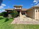 Attractive single-story home features a manicured lawn, fountain, and a brick-paved walkway leading to the front entrance at 5005 Pebble Beach Blvd, Winter Haven, FL 33884