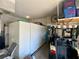 Spacious garage featuring ample storage cabinets, a golf cart, and shelving for organization at 5005 Pebble Beach Blvd, Winter Haven, FL 33884