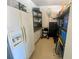 Clean utility garage with shelving and storage space; equipped with a fridge and a utility sink at 5005 Pebble Beach Blvd, Winter Haven, FL 33884
