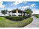 Community gazebo overlooking the lake and walking path surrounded by green space at 5005 Pebble Beach Blvd, Winter Haven, FL 33884