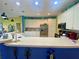 Spacious kitchen featuring white cabinets, stainless steel appliances, and bar counter for seating at 5005 Pebble Beach Blvd, Winter Haven, FL 33884