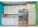 Modern kitchen with stainless steel refrigerator, ample cabinet space, and stylish backsplash at 5005 Pebble Beach Blvd, Winter Haven, FL 33884
