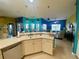 Spacious kitchen with white countertops and cabinets overlooking the adjacent living areas at 5005 Pebble Beach Blvd, Winter Haven, FL 33884