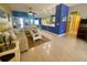 Bright living room with colorful walls, comfortable seating, and tile flooring throughout the home at 5005 Pebble Beach Blvd, Winter Haven, FL 33884