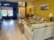 Cozy living room with striped sofas, tile floors, and bright, cheerful yellow walls at 5005 Pebble Beach Blvd, Winter Haven, FL 33884