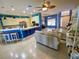 Open-concept living space with a modern kitchen, comfortable seating, and bright, colorful accents at 5005 Pebble Beach Blvd, Winter Haven, FL 33884