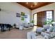 Elegant lounge featuring a piano, comfortable seating, and natural light for relaxing and socializing at 5005 Pebble Beach Blvd, Winter Haven, FL 33884