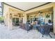 Spacious patio with comfortable seating, ceiling fans, and sliding glass doors for indoor-outdoor living at 5005 Pebble Beach Blvd, Winter Haven, FL 33884