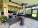 Inviting covered patio featuring comfortable seating, ceiling fan, heater, and entertainment center at 5005 Pebble Beach Blvd, Winter Haven, FL 33884