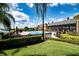 Community pool area with ample lounge seating and views of the lake and clubhouse at 5005 Pebble Beach Blvd, Winter Haven, FL 33884