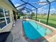 Screened in pool with ample patio space and a beautiful backyard view at 5005 Pebble Beach Blvd, Winter Haven, FL 33884