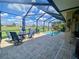 Screened-in lanai featuring a pool with ample seating for entertaining and enjoying outdoor living at 5005 Pebble Beach Blvd, Winter Haven, FL 33884
