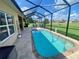 Backyard pool with screened in patio, brick pavers, and serene backyard view at 5005 Pebble Beach Blvd, Winter Haven, FL 33884