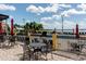 Poolside patio featuring ample seating and views of the water at 5005 Pebble Beach Blvd, Winter Haven, FL 33884