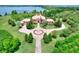 Aerial view showcasing circular drive, lush landscaping and a tile roof at 501 Adams Barn Rd, Auburndale, FL 33823