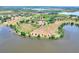 A sprawling estate with a pool, tennis court, and lush landscaping near the lake at 501 Adams Barn Rd, Auburndale, FL 33823