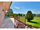 Upper balcony showcasing the yard, lake views, and rod iron railings at 501 Adams Barn Rd, Auburndale, FL 33823