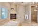 Elegant bathroom with a soaking tub, fireplace, shower, and chandelier at 501 Adams Barn Rd, Auburndale, FL 33823