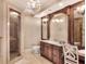 Elegant bathroom features a glass shower, vanity and a beautiful chandelier at 501 Adams Barn Rd, Auburndale, FL 33823