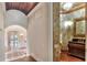 Luxurious powder room features a custom vanity and ornate sconces and mirror at 501 Adams Barn Rd, Auburndale, FL 33823