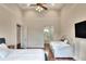 This bedroom features two beds, a ceiling fan and convenient ensuite bathroom access at 501 Adams Barn Rd, Auburndale, FL 33823