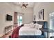 This bedroom features two beds, a mounted television and french doors to the backyard at 501 Adams Barn Rd, Auburndale, FL 33823