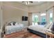 This bedroom boasts a high ceiling, two beds and french doors leading to the backyard at 501 Adams Barn Rd, Auburndale, FL 33823