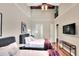 This bedroom features two beds, a mounted television and ensuite bathroom access at 501 Adams Barn Rd, Auburndale, FL 33823