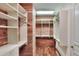 Walk-in closet featuring custom shelving and cedar wood accents at 501 Adams Barn Rd, Auburndale, FL 33823