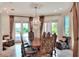Formal dining room featuring a chandelier, a large table with seating for eight, and water views at 501 Adams Barn Rd, Auburndale, FL 33823