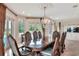 Formal dining room with chandelier, large table, and lots of light from outdoor views at 501 Adams Barn Rd, Auburndale, FL 33823