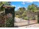 Elegant wrought iron gate with lush landscaping welcomes you to Casa Bella at 501 Adams Barn Rd, Auburndale, FL 33823