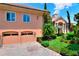 Elegant exterior of a home showing the garage, driveway, and manicured lawn at 501 Adams Barn Rd, Auburndale, FL 33823