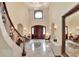 Grand foyer featuring soaring ceilings, elegant staircase, chandelier and marble floors at 501 Adams Barn Rd, Auburndale, FL 33823