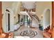 Elegant foyer with marble floors, a curved staircase, and high ceilings, creating a grand entrance at 501 Adams Barn Rd, Auburndale, FL 33823