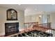 Inviting game room features a fireplace, foosball table, and hardwood floors perfect for leisure at 501 Adams Barn Rd, Auburndale, FL 33823