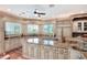 Spacious kitchen featuring granite counters and an island cooktop at 501 Adams Barn Rd, Auburndale, FL 33823