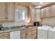 Well-equipped laundry room featuring custom cabinetry, granite countertops, and modern appliances at 501 Adams Barn Rd, Auburndale, FL 33823