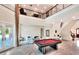 Spacious living room with marble flooring, a pool table, and a staircase to the second level at 501 Adams Barn Rd, Auburndale, FL 33823