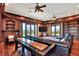 Spacious living room features a shuffleboard table and lake views from many windows and doors at 501 Adams Barn Rd, Auburndale, FL 33823