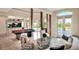 Elegant living room featuring a pool table, a fish tank, comfortable seating, and large windows at 501 Adams Barn Rd, Auburndale, FL 33823