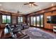 Spacious living room with wood paneled walls, built-in shelving, and lake views at 501 Adams Barn Rd, Auburndale, FL 33823