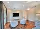 Cozy living room features hardwood floors, comfortable seating, and a large TV, perfect for relaxation and entertainment at 501 Adams Barn Rd, Auburndale, FL 33823