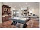Large open living space with an air hockey table, bar, and living room at 501 Adams Barn Rd, Auburndale, FL 33823