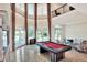 Grand living room features two-story ceilings, large windows, and an elegant billiards table at 501 Adams Barn Rd, Auburndale, FL 33823